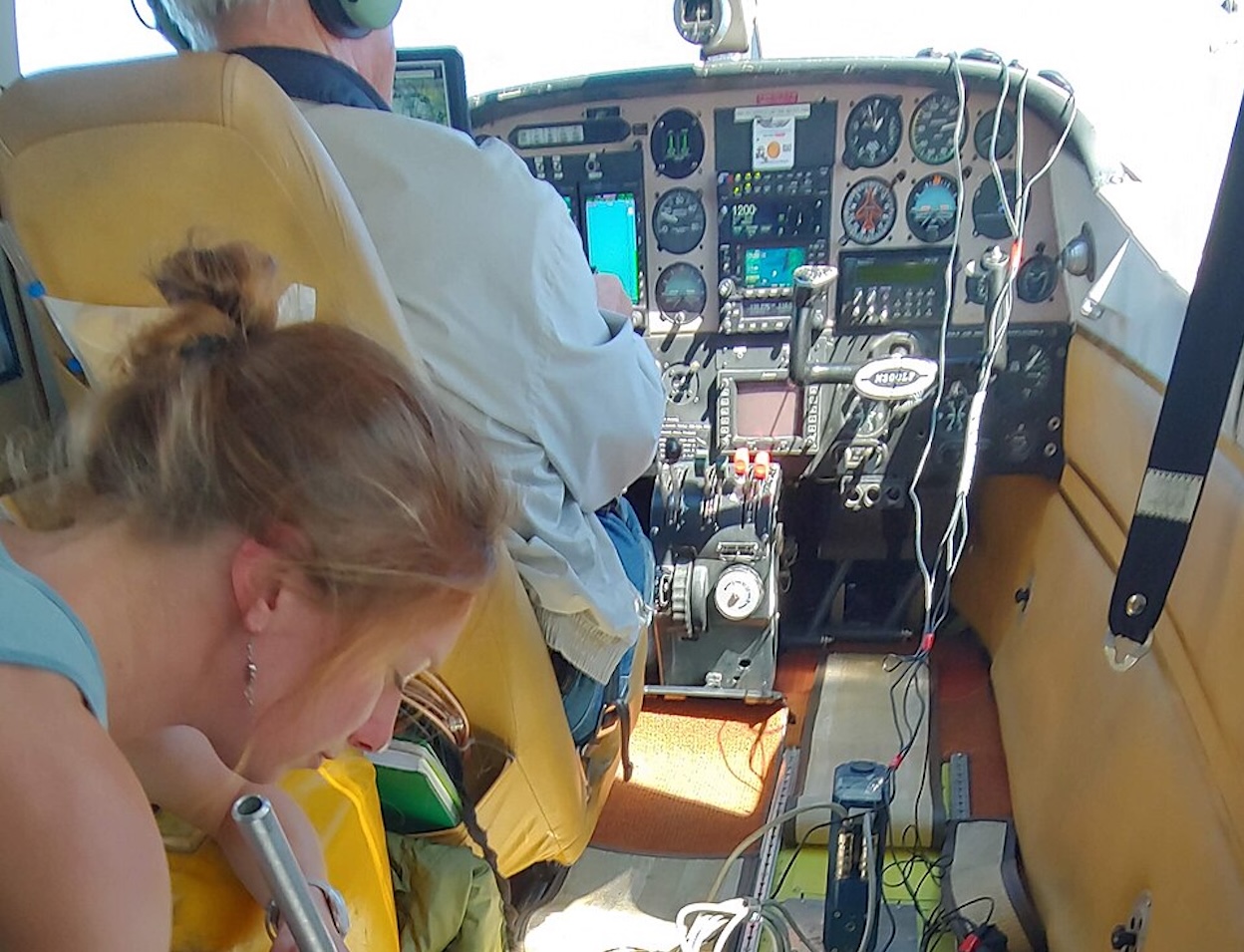 Adjusting a camera during an aerial photographic survey - Cheryl Horton (USGS Western Ecological Research Center)]